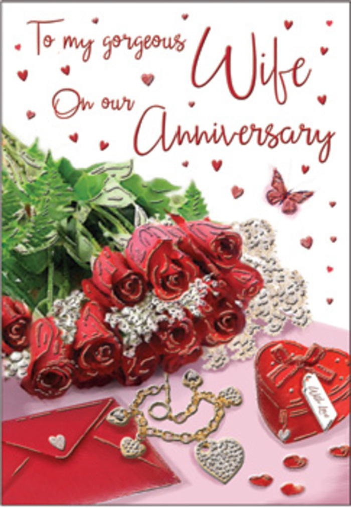 The anniversary card shown in this image captures the feeling of an intimate celebration, like an evening at home in Hornsey after a favourite meal shared together. Central to the design is a posy of deep red roses, their petals rich and velvety, curling in soft spirals toward the centre of each bloom. The roses appear almost three-dimensional, as if they might spill from the card, supported by lush greenery that adds fullness and grace. To one side rests a smooth envelope, its pale surface slightly lifted, hinting at a handwritten message tucked within-perhaps recalling strolls through nearby Priory Park or quiet weekends in Crouch End. A plush, heart-shaped jewellery box in scarlet red, neatly tied with a ribbon, anchors the arrangement with a sense of occasion. Laid beside it is a delicate golden necklace, its intertwined heart pendant forming a symbol of two lives linked together. Sparkling decorative elements and tiny heart confetti are scattered around, lending the surface a subtle glitter that catches the light. The message on the card is arranged in flowing, elegant script, curving around the roses and keepsakes in a way that feels balanced and harmonious. Gentle, warm lighting envelopes the entire composition, picking up the sheen of metal, the softness of petals, and the smoothness of the envelope. Shadows are soft and understated, creating depth without harshness. The overall impression is one of warmth, intimacy, and long-term commitment-a timeless expression of love that feels perfectly at home in the relaxed, romantic atmosphere of Hornsey's neighbourhood streets.